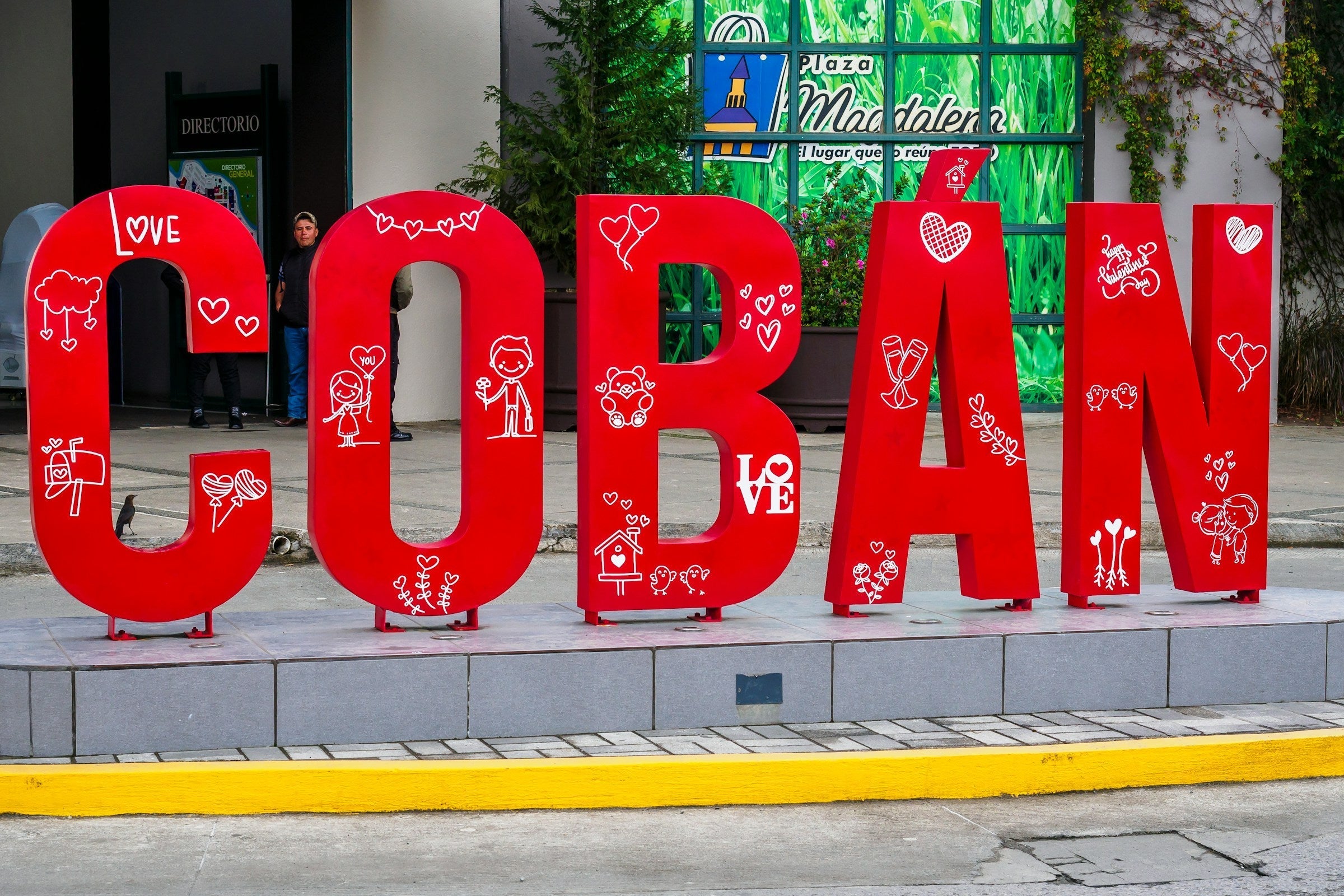 Large red lettering spelling out Coban as a sign on the street