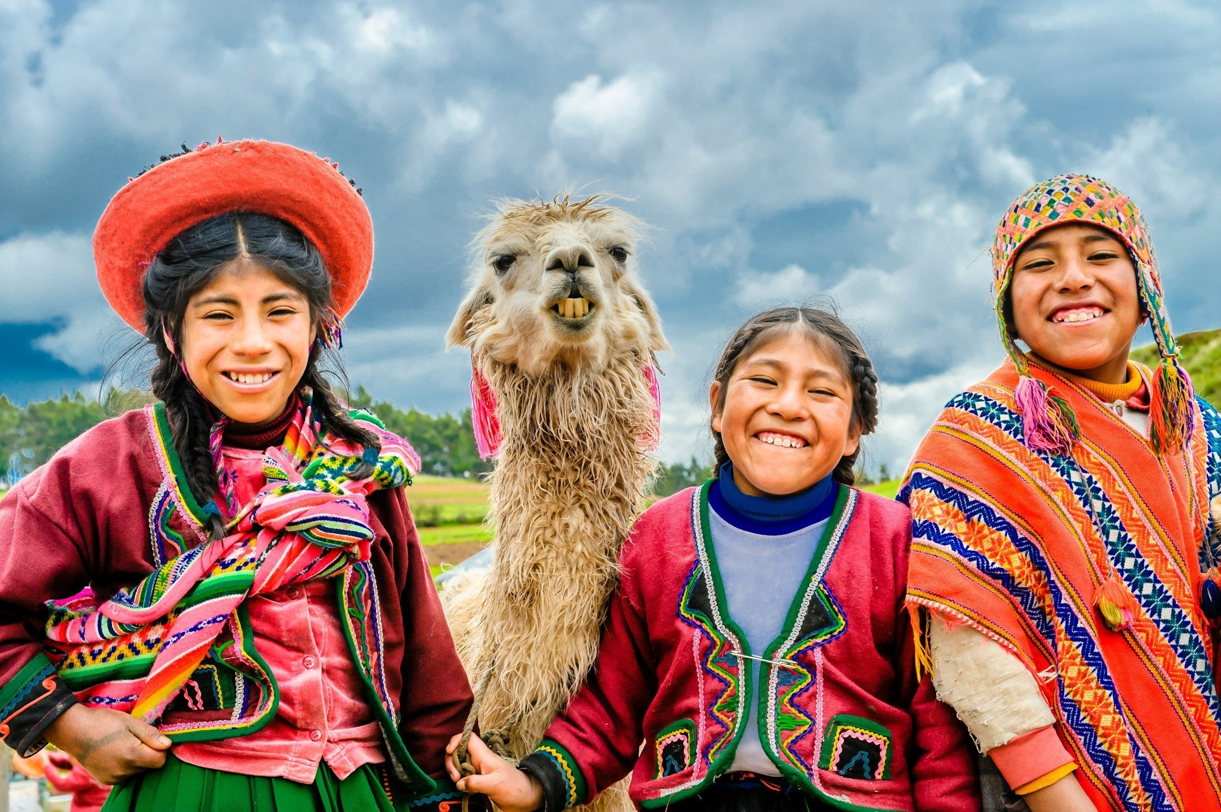Happy people and a llama in Cusco, Peru