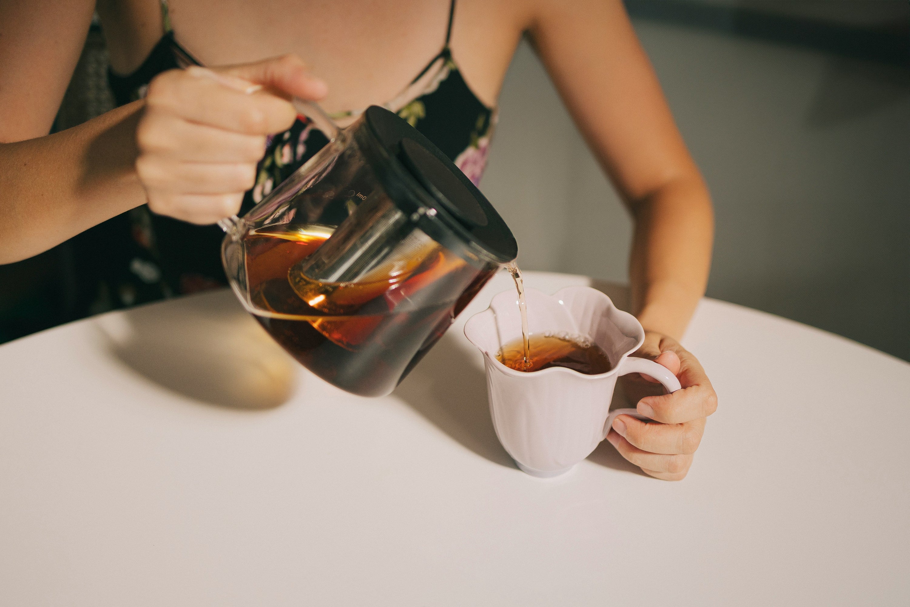 coffee being poured from coffee jug into cup