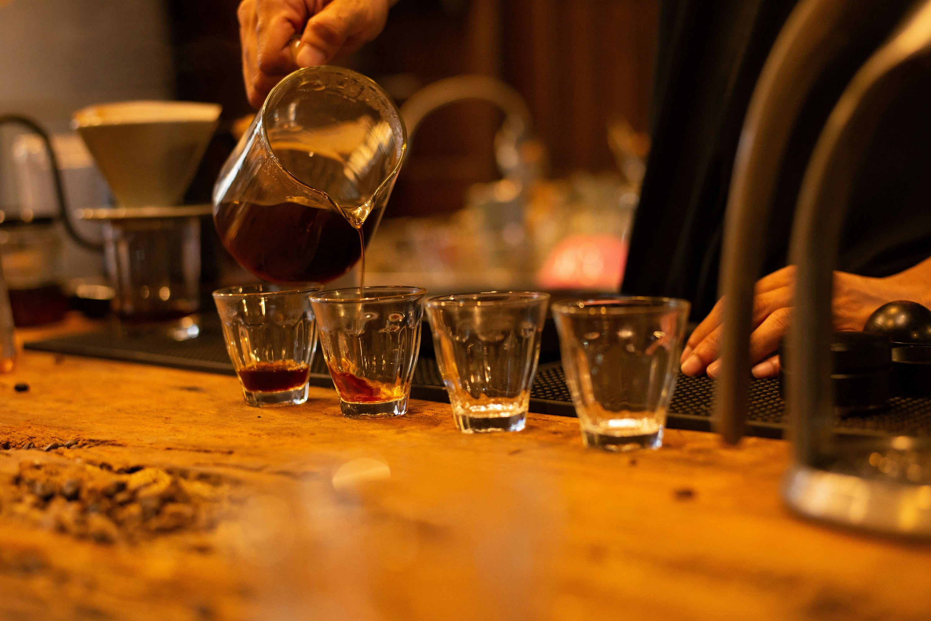 pouring coffee from carafe into coffee glasses