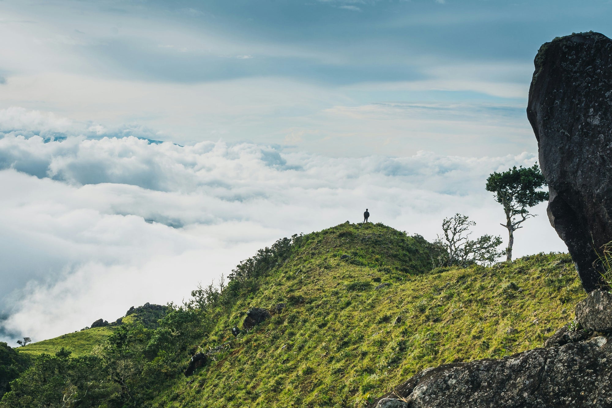 Man stands on mountaintop above cloud line in Boquete Panama 