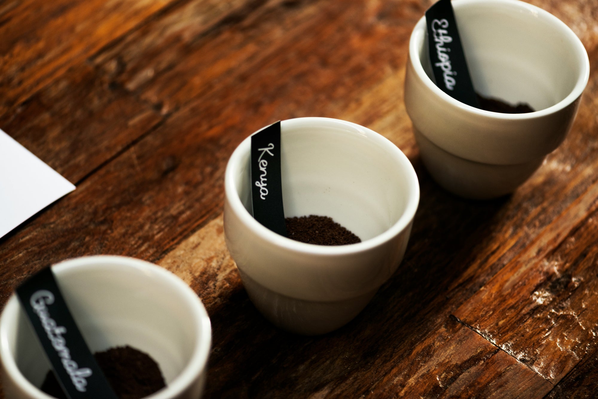 Ethiopia Guatemala Kenya coffee grounds sitting in coffee cups