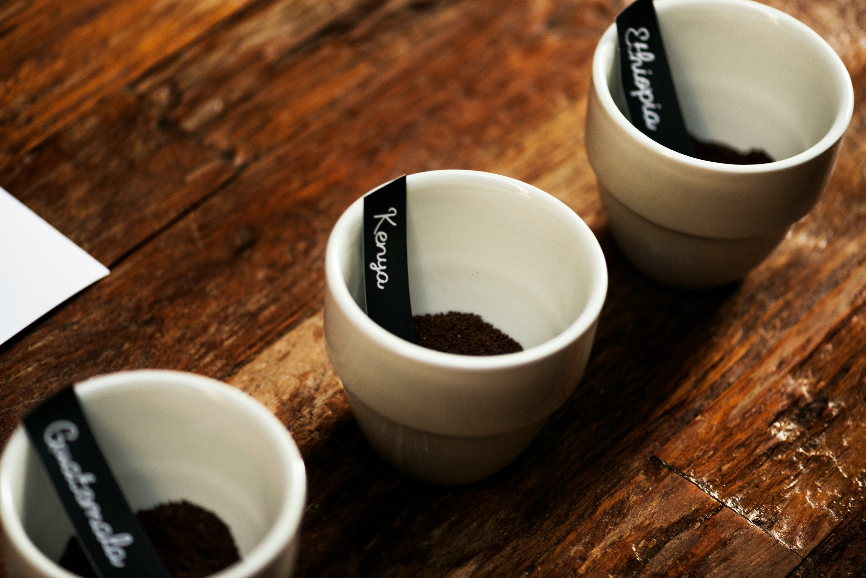 Ethiopia Guatemala Kenya coffee grounds sitting in coffee cups