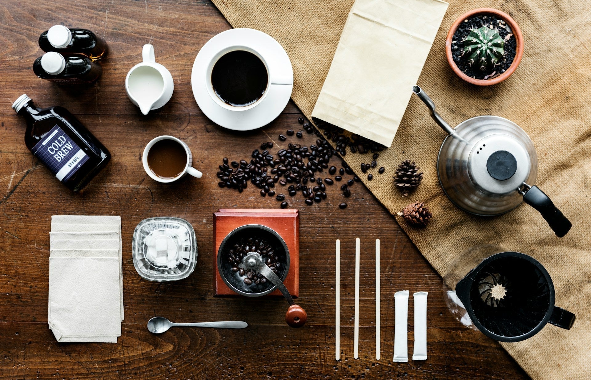 Assorted coffee making equipment lying on a wooden table