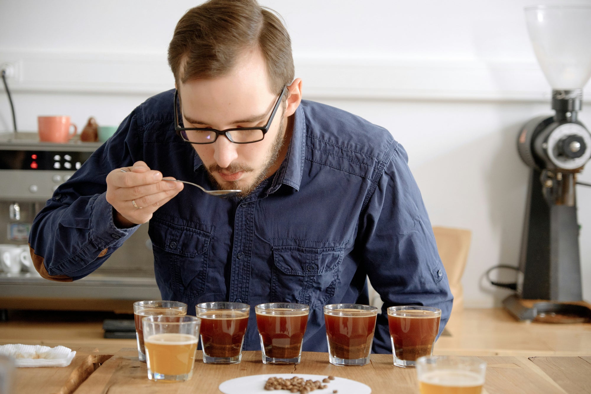 man coffee cupping in kitchen environment