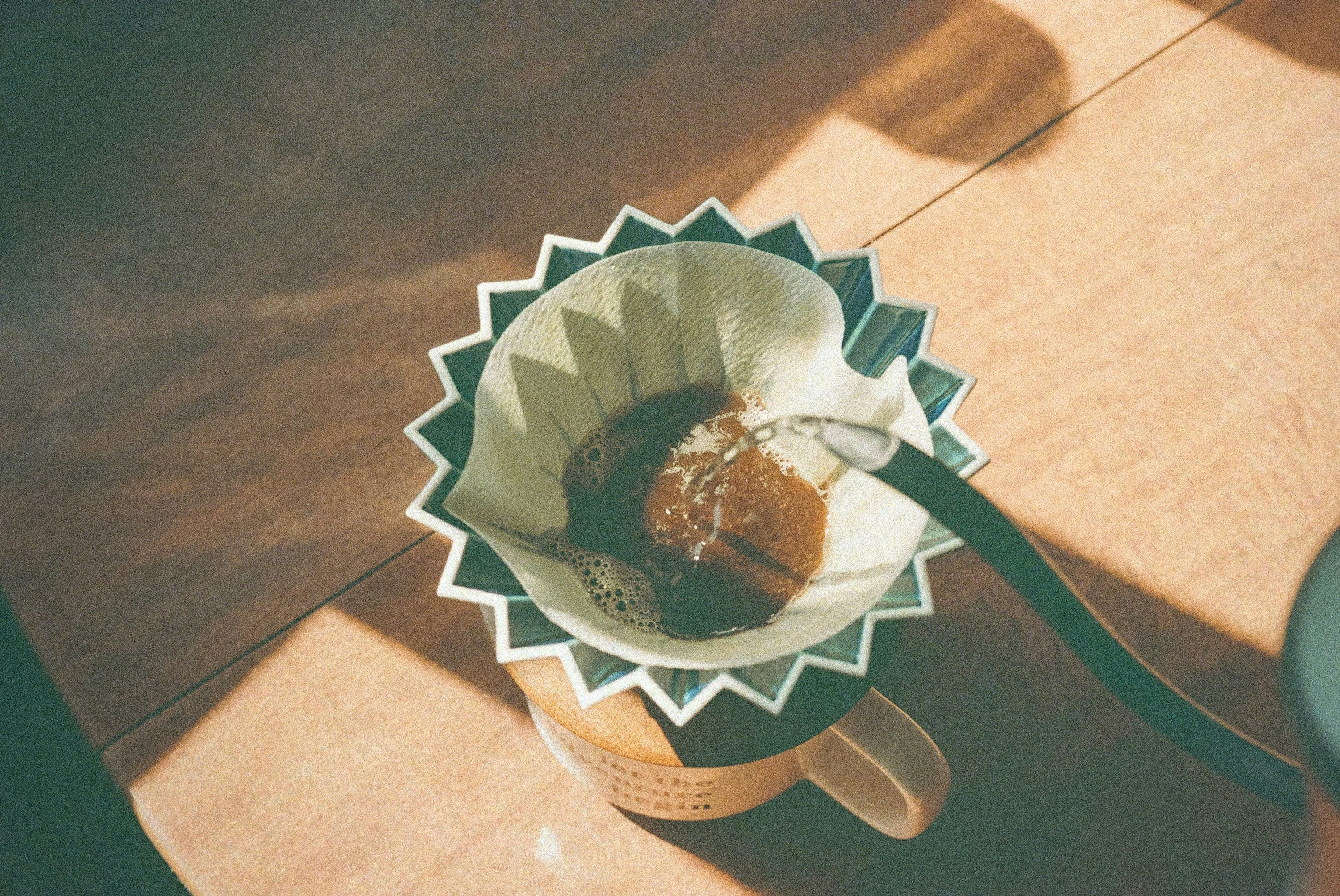 Pour over coffee being made with water pouring from kettle