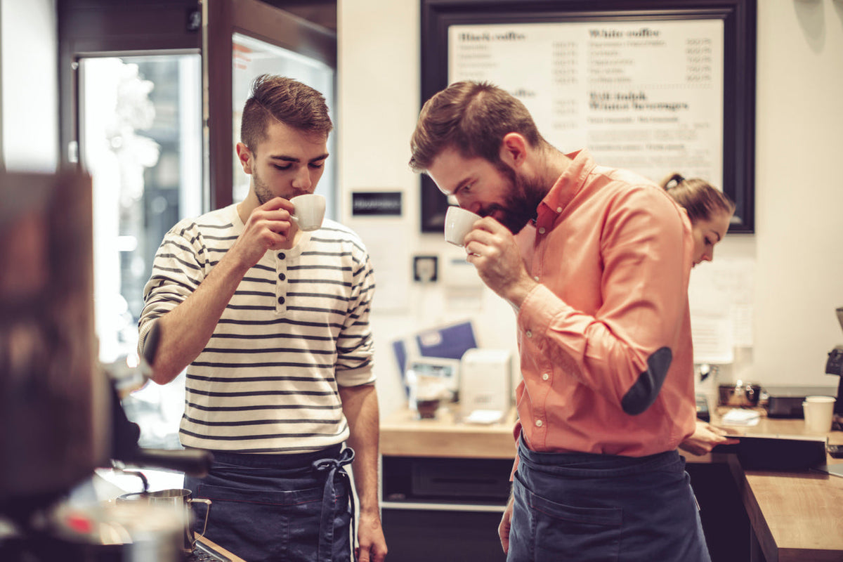 Two people tasting coffee