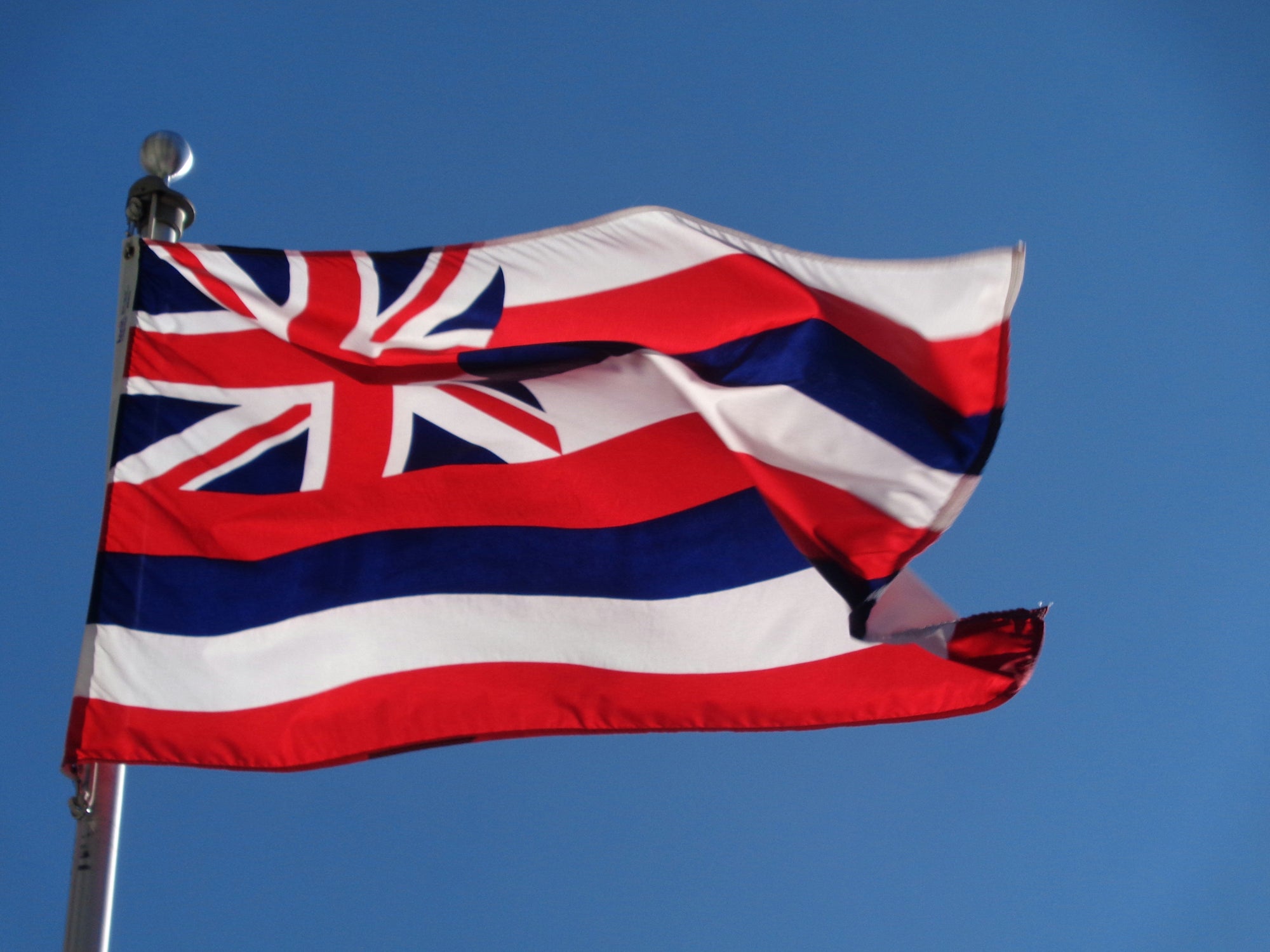 hawaii flag against a blue sky