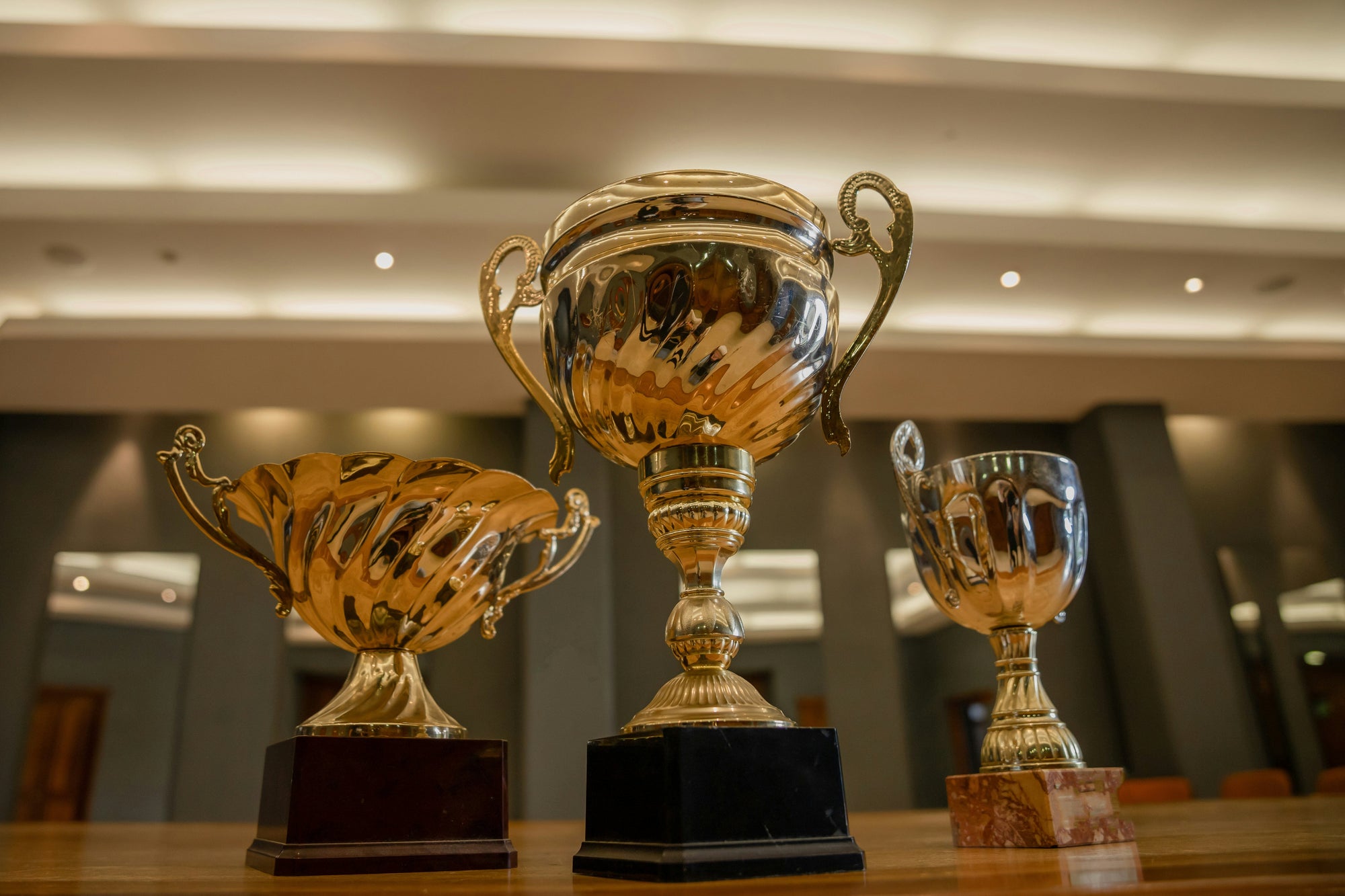 three trophies on wooden table