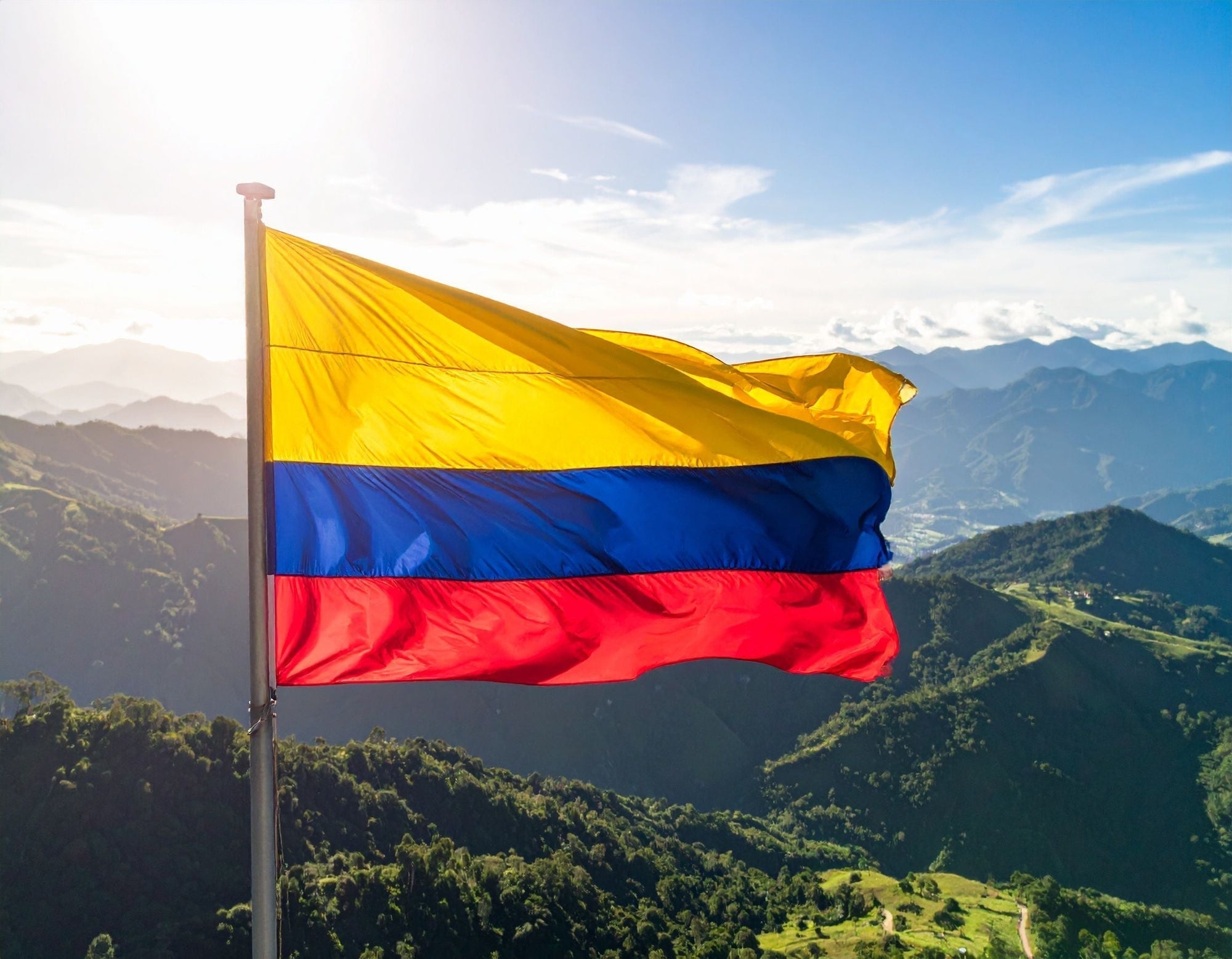 Colombia flag against a verdant mountainscape