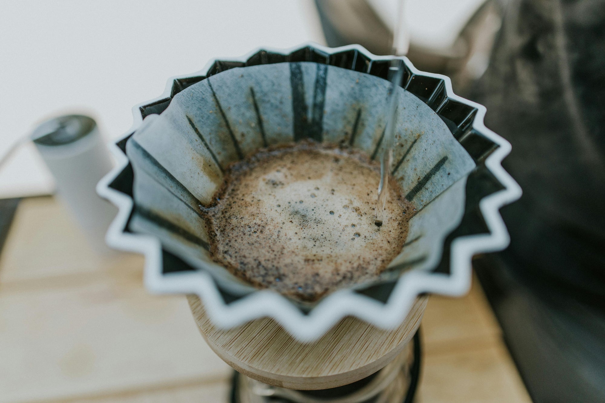 water being poured into pour over coffee dripper