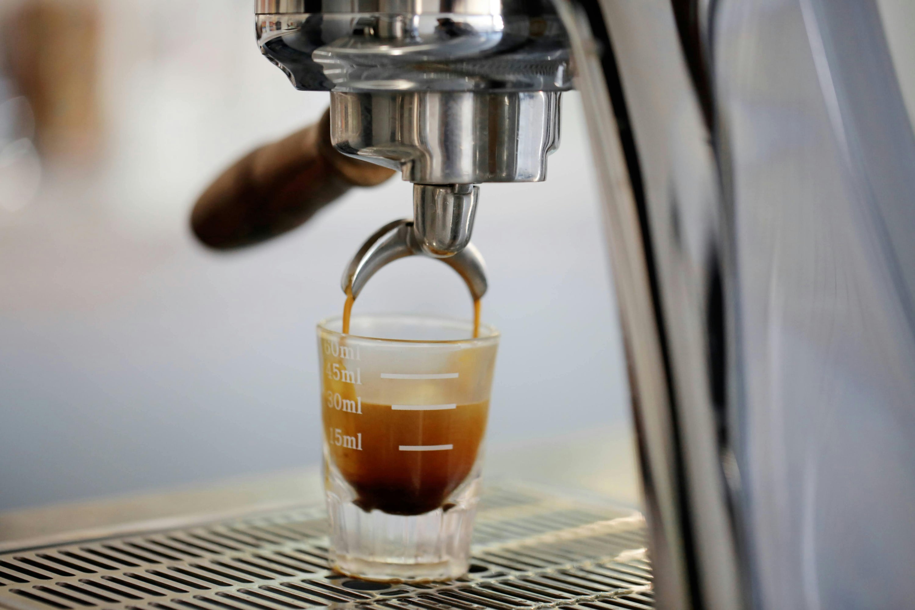 espresso shot being pulled into single espresso glass