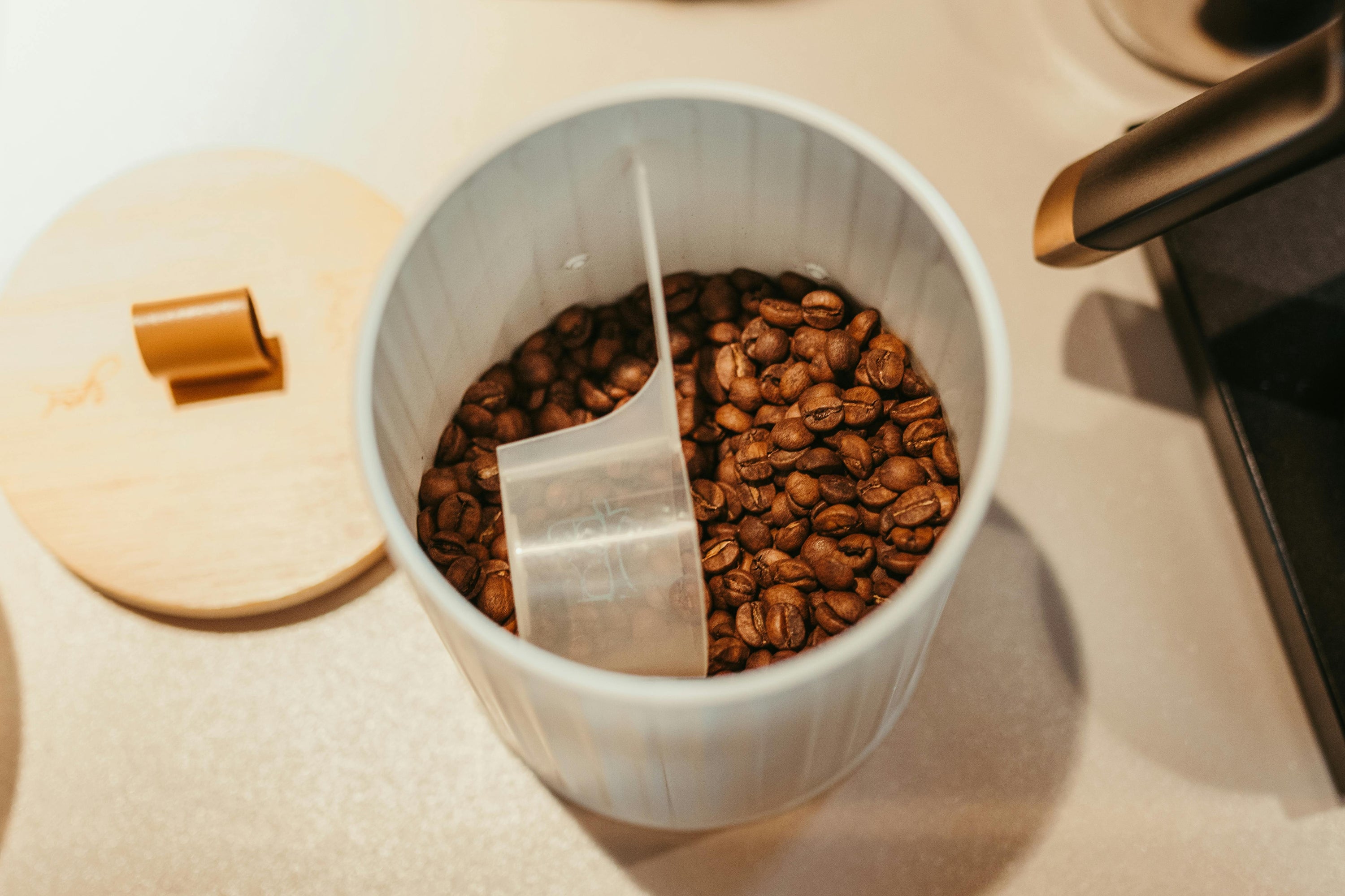coffee container with coffee beans and measuring device inside
