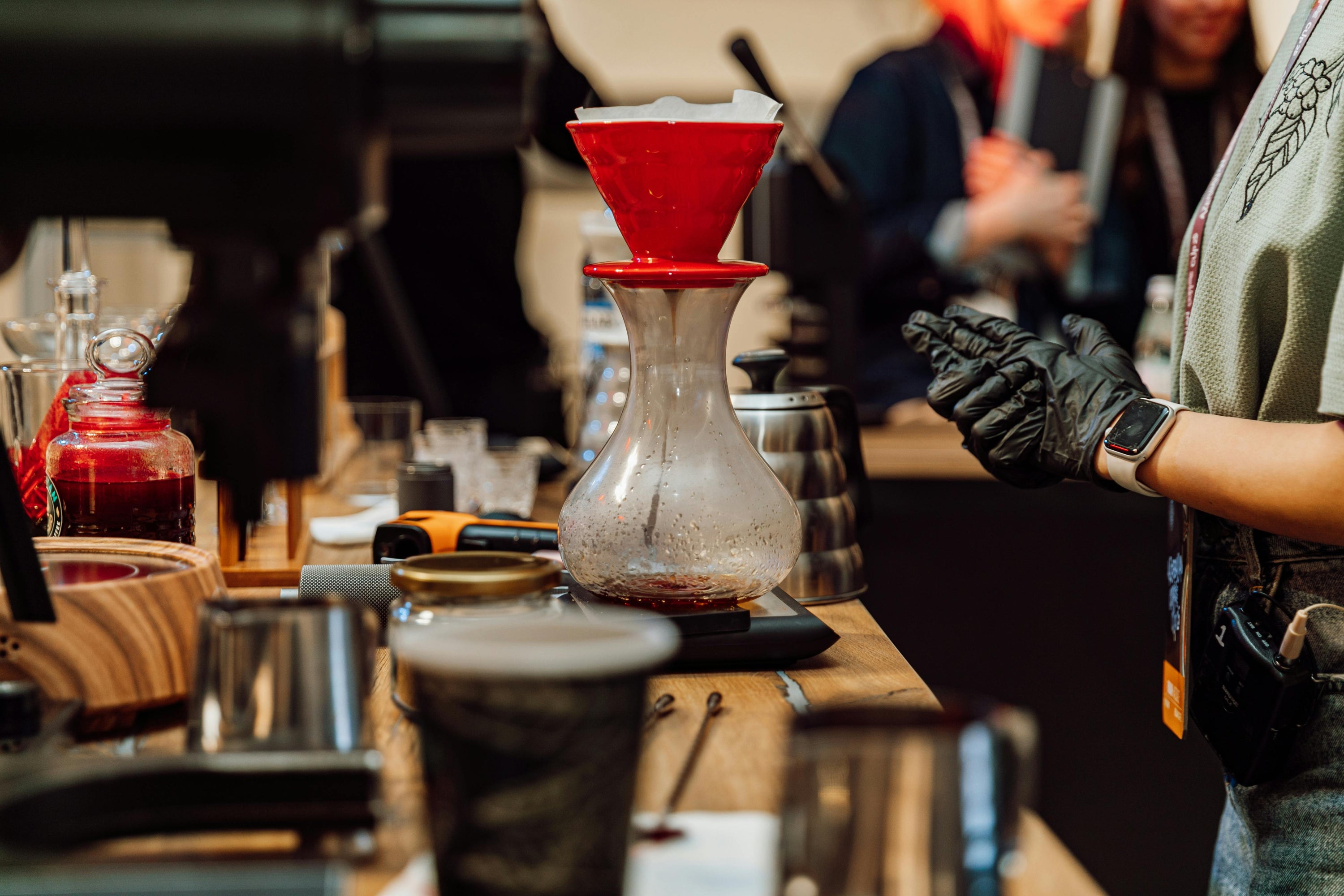 coffee competition taking place with multiple coffee drippers and contesants