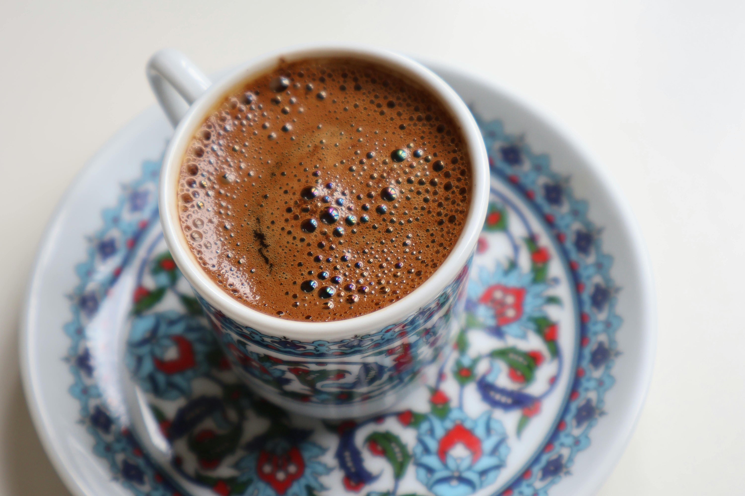 turkish coffee in ornately patterned coffee cup and saucer