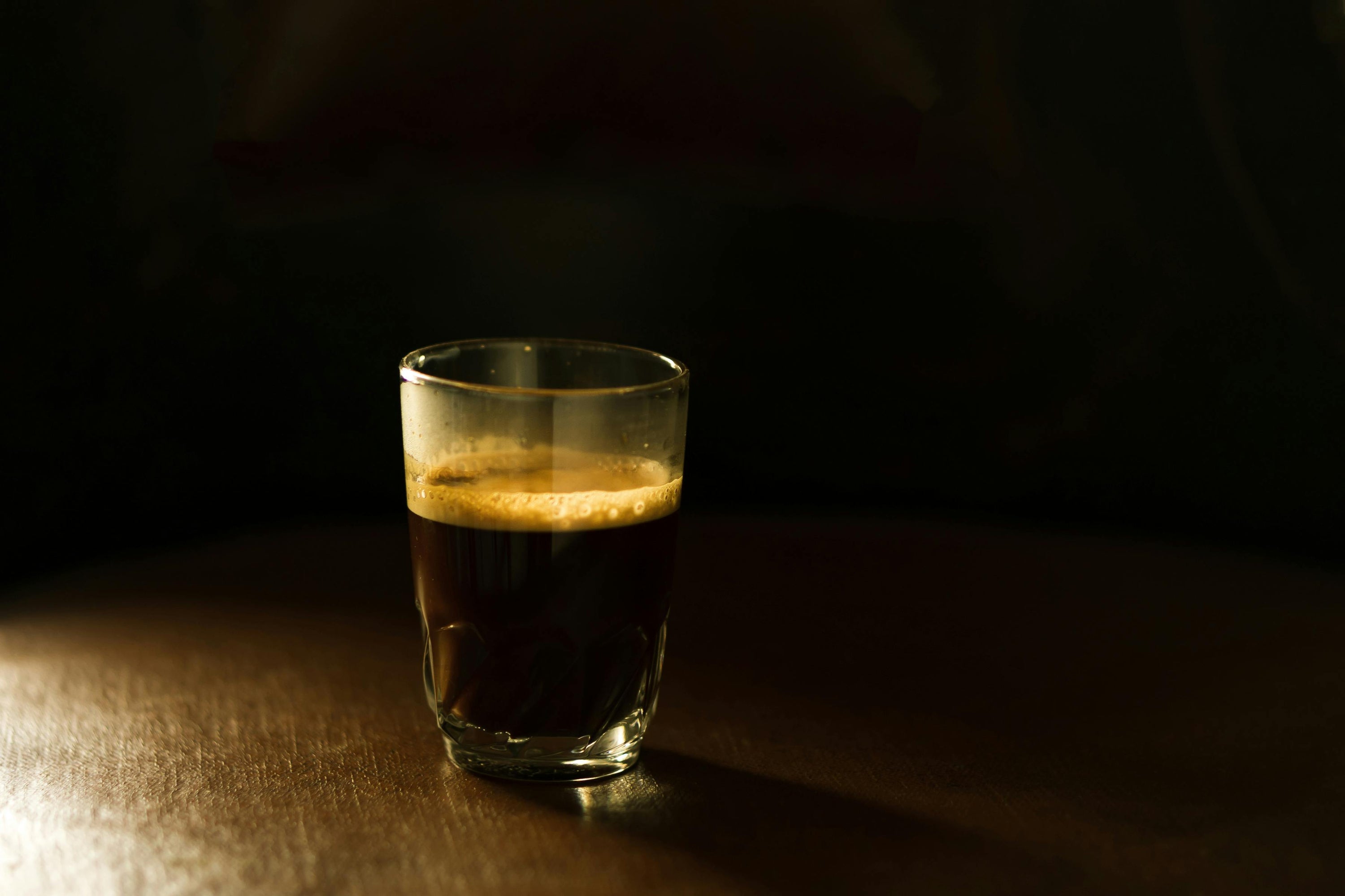 espresso shot sitting on wooden countertop