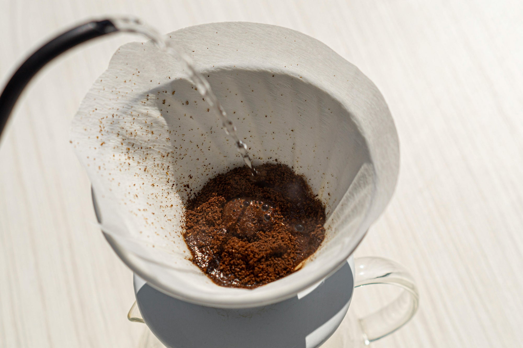 pour over coffee grounds being bloomed