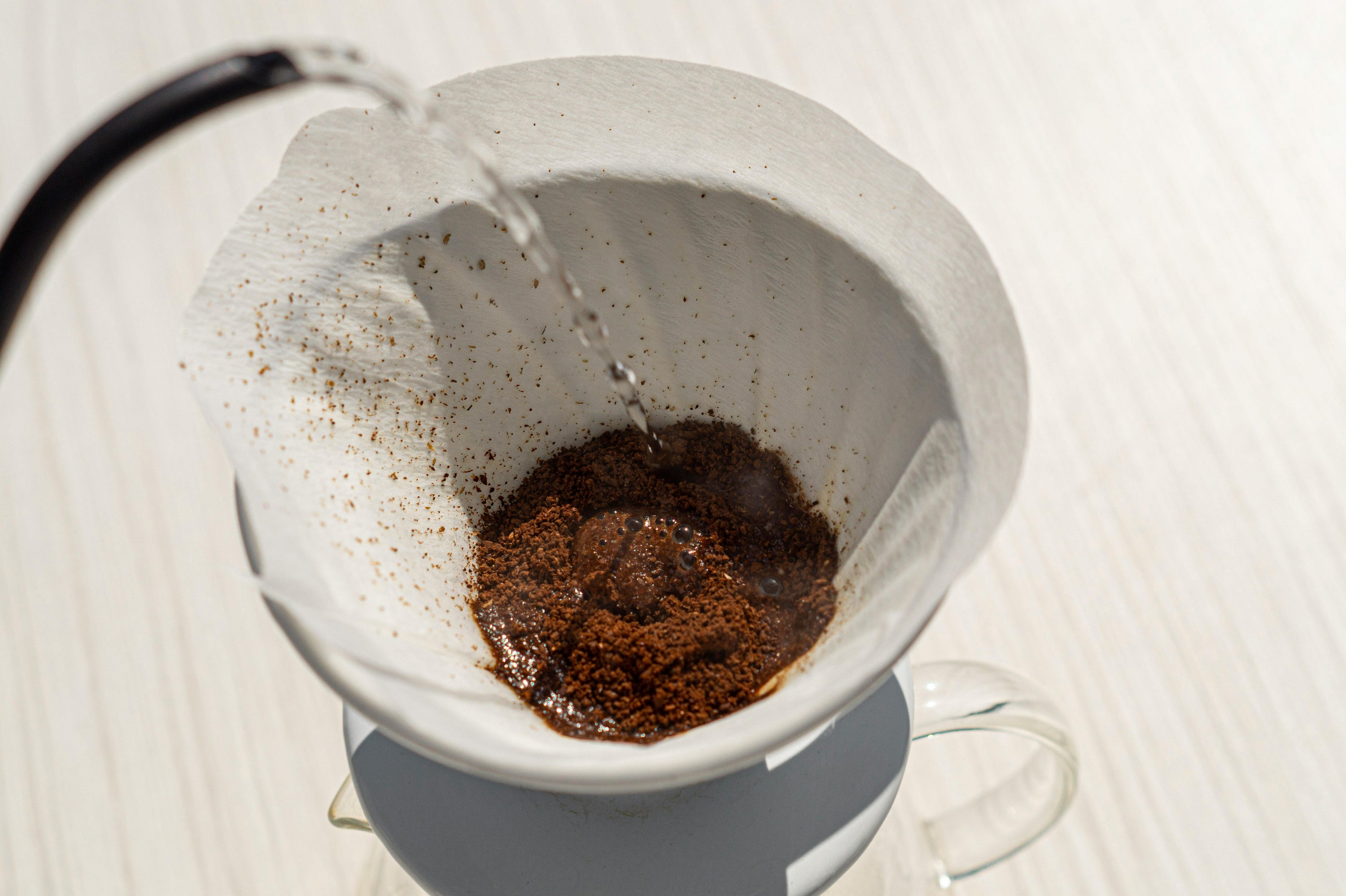 pour over coffee grounds being bloomed