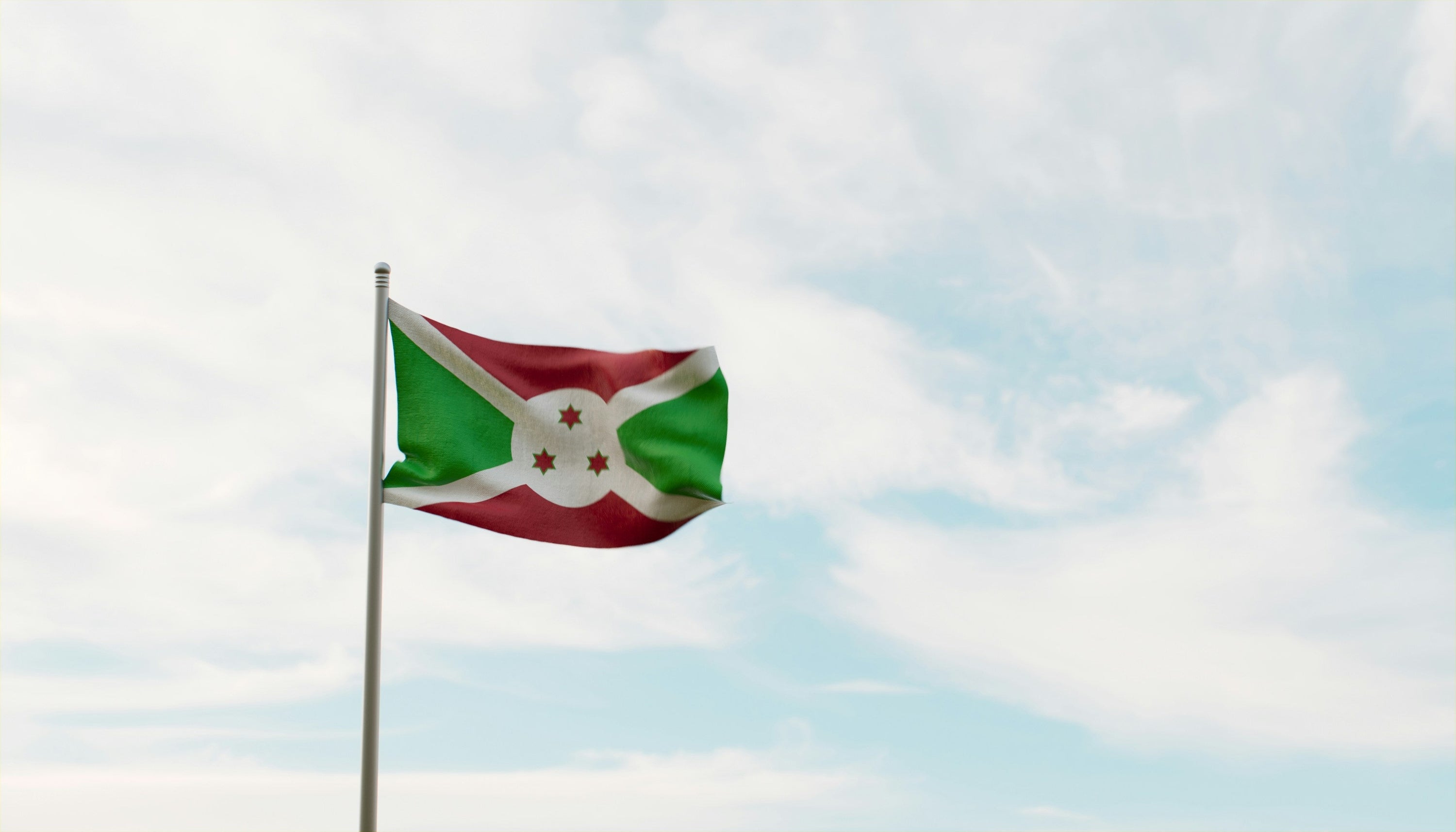 Burundi flag against a blue sky