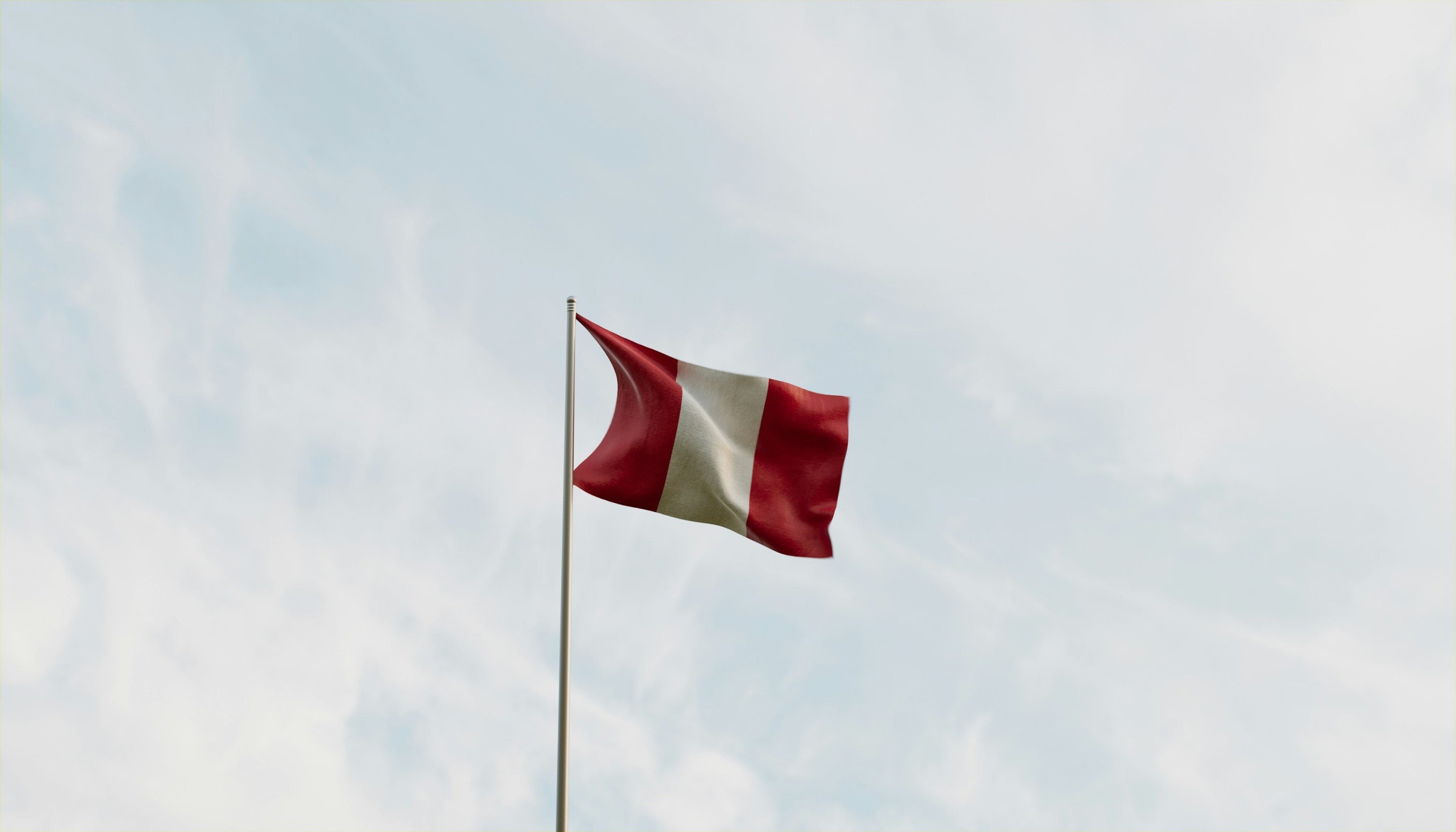 peru flag against a blue sky