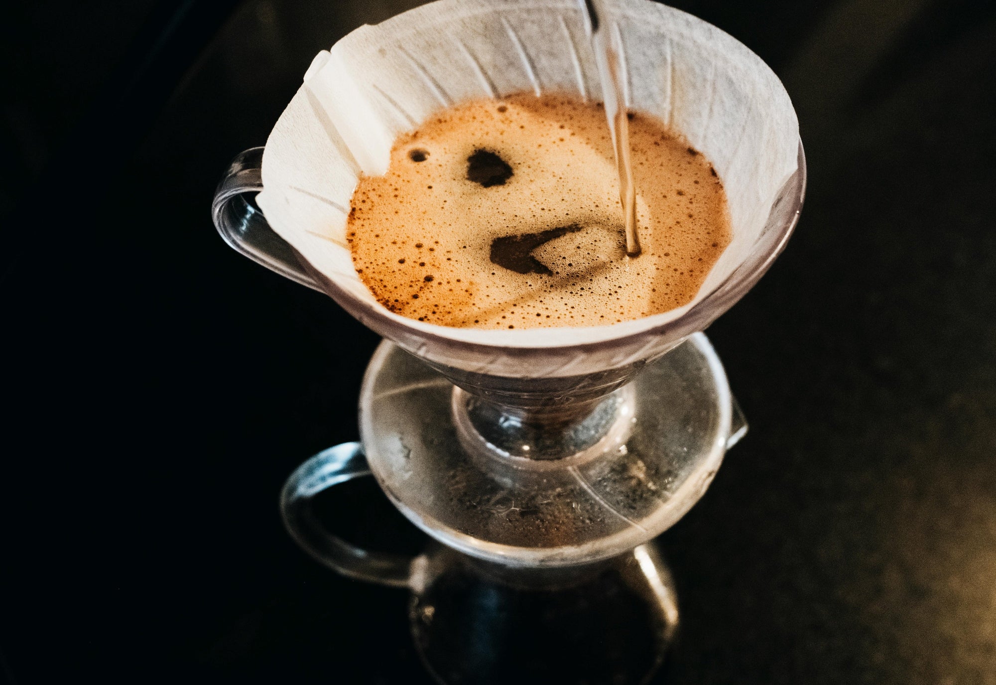 pour over coffee being made against black background