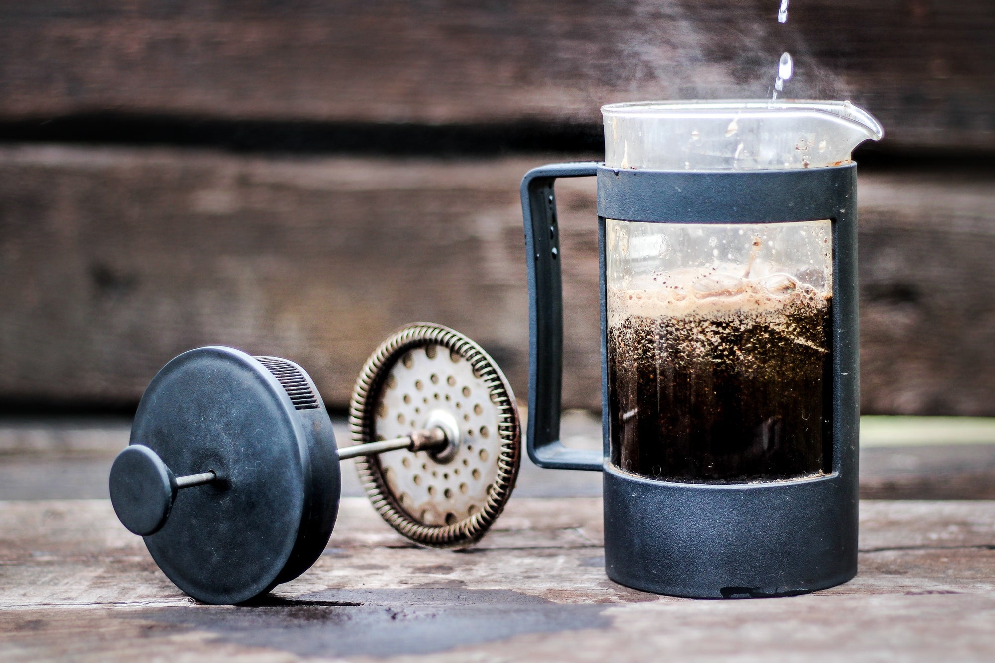 Steamy French press coffee being poured