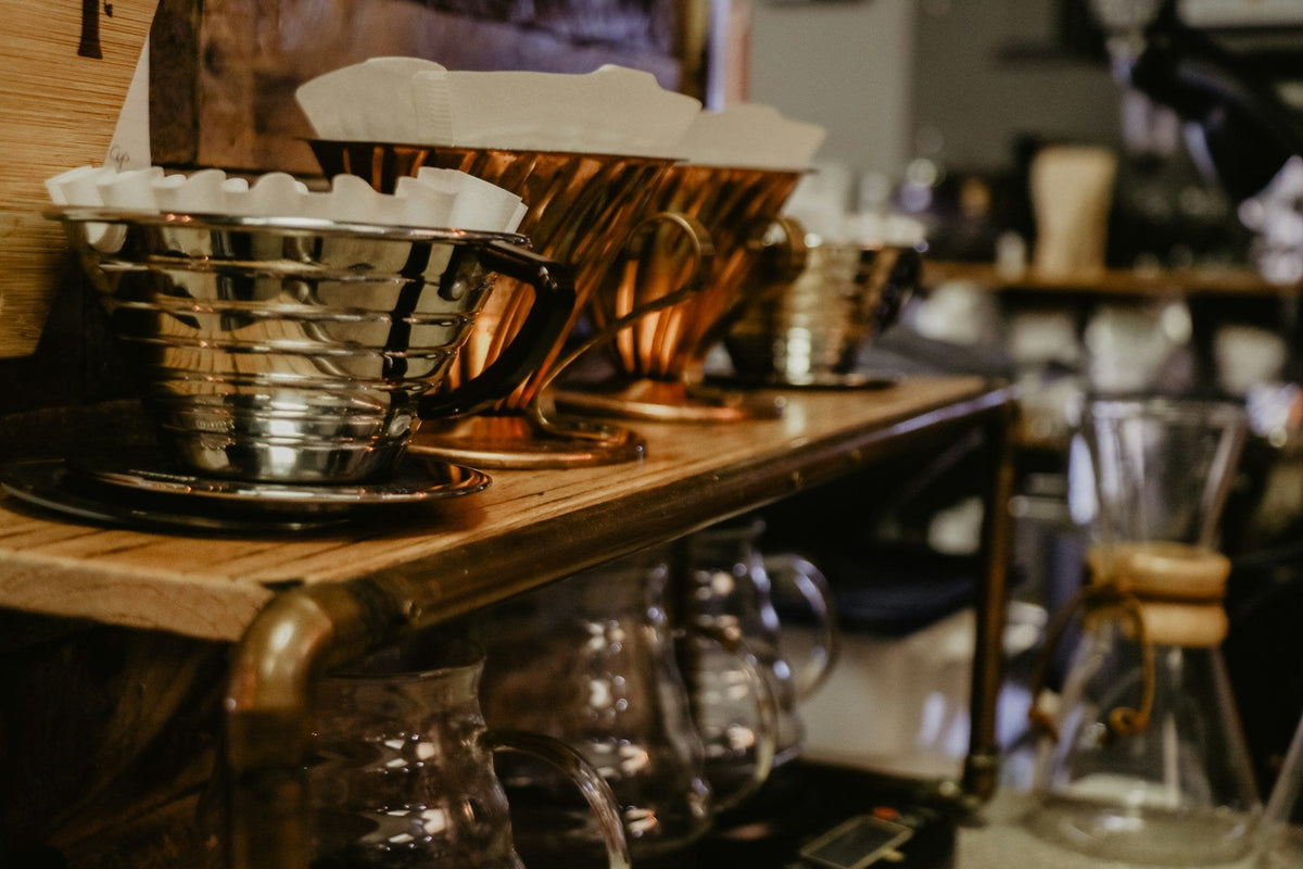 Multiple Kalita Wave coffee brewers being prepared for brewing.