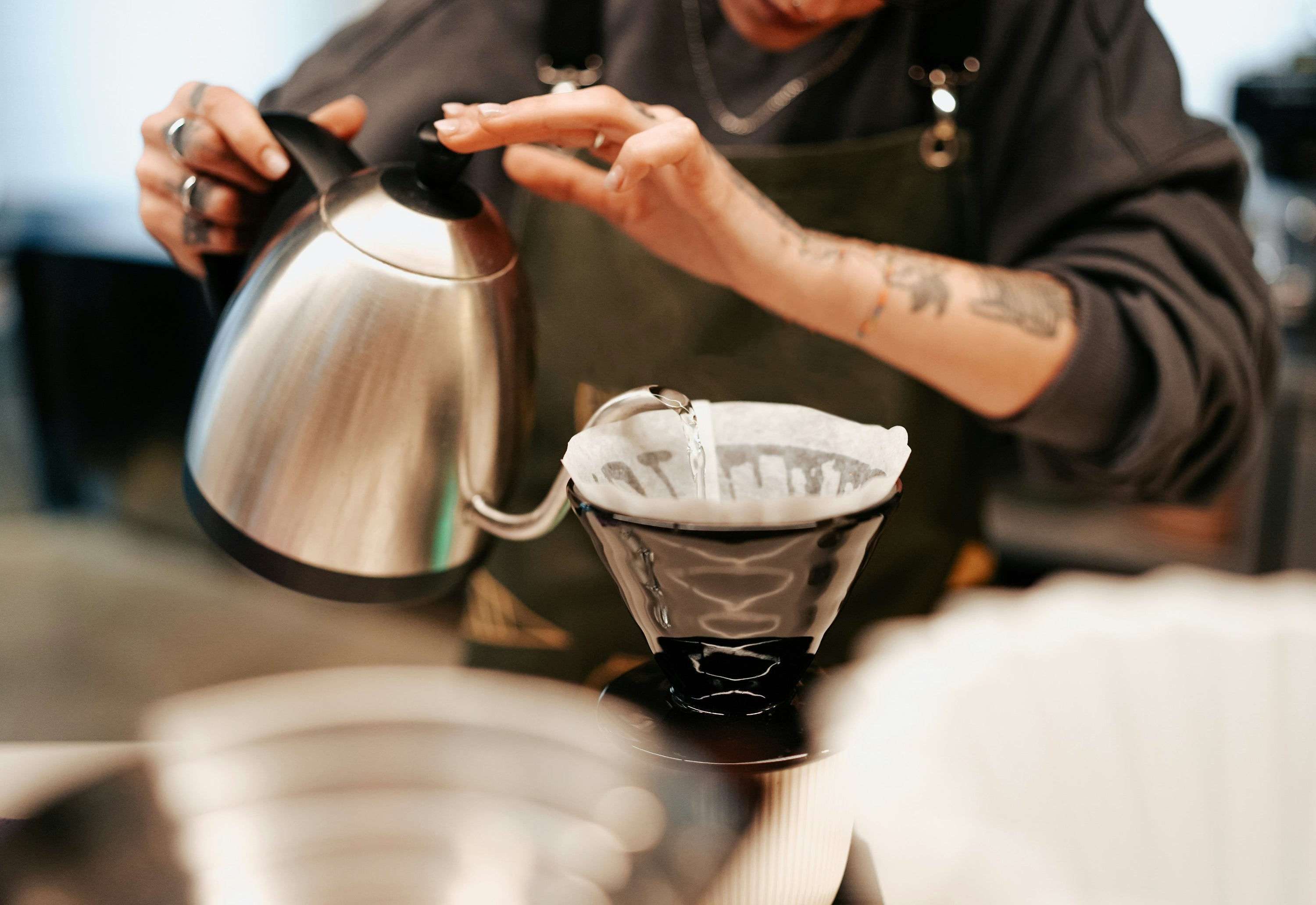 pour over coffee filter being rinsed with water prior to brewing