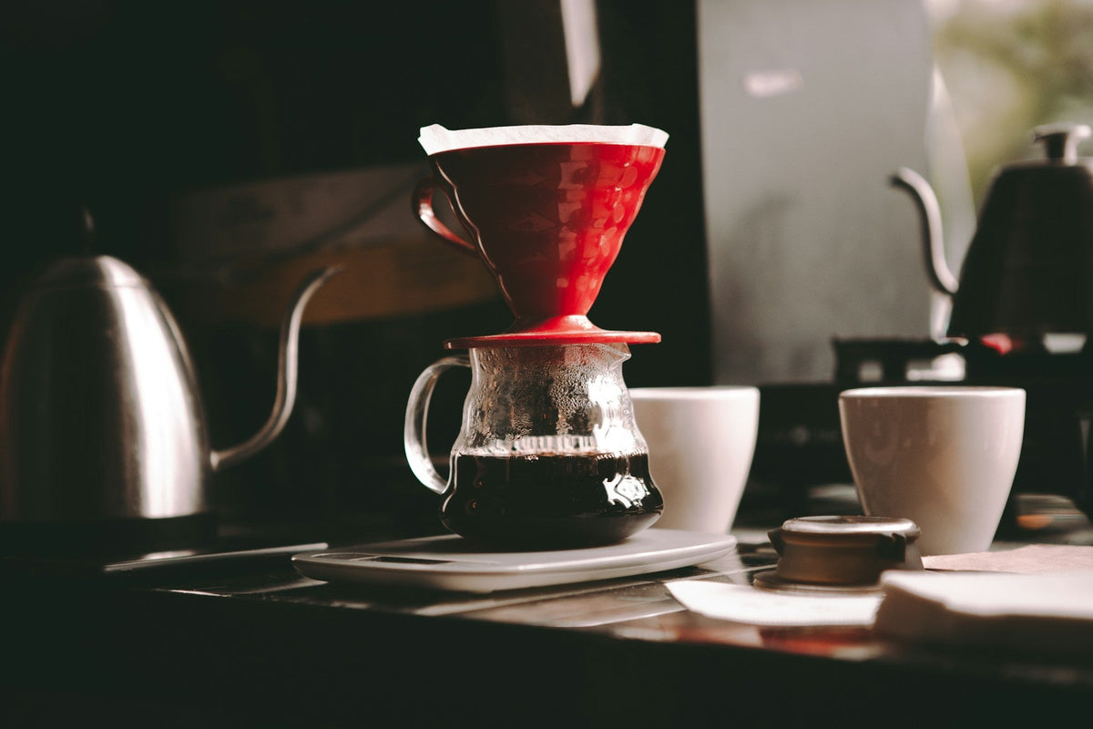 Red Hario V60 coffee brewer on clear coffee jug