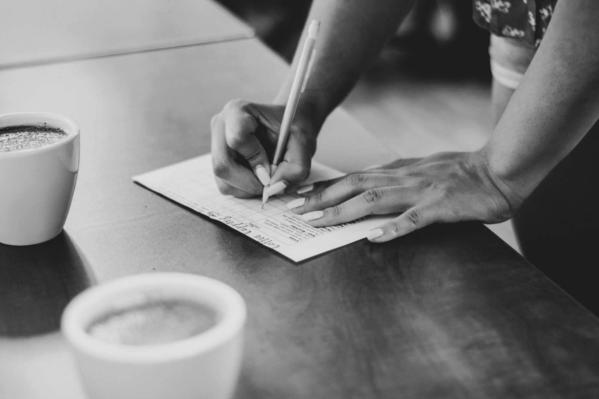 coffee cupping with person taking notes on flavors