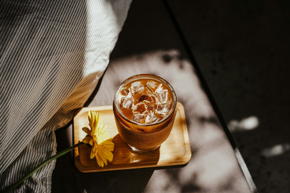 cold brew coffee sitting on wooden tray