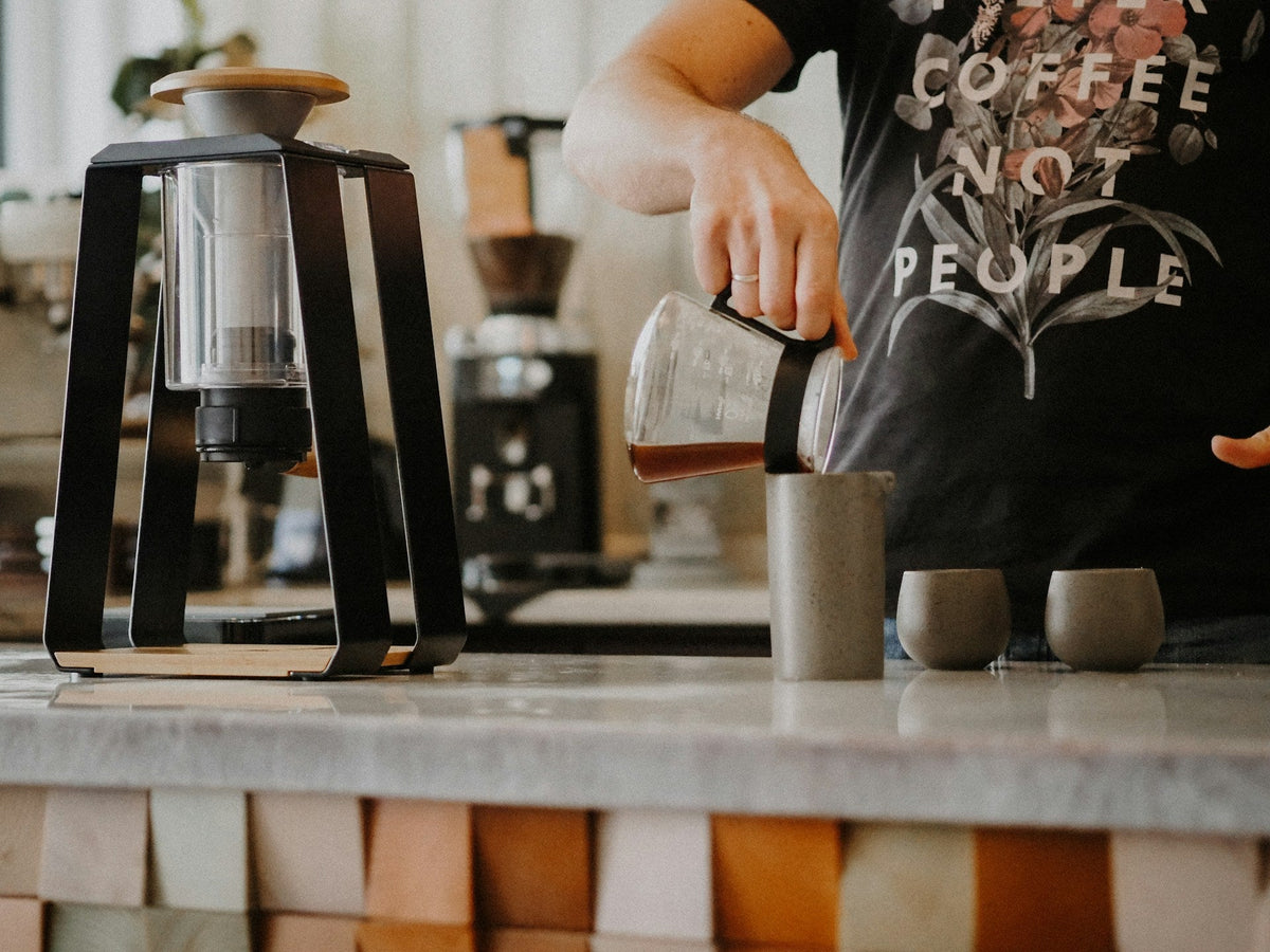 barista working in minimalist coffee shop