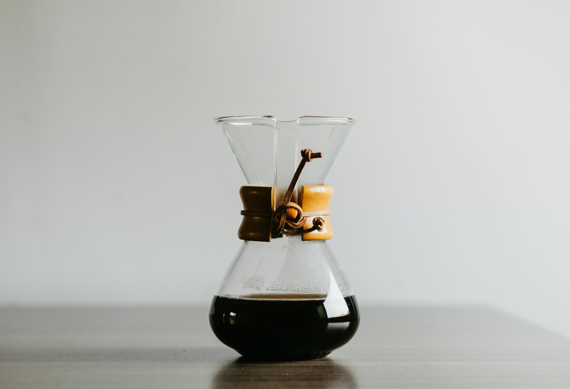 chemex coffee maker sitting on dark countertop